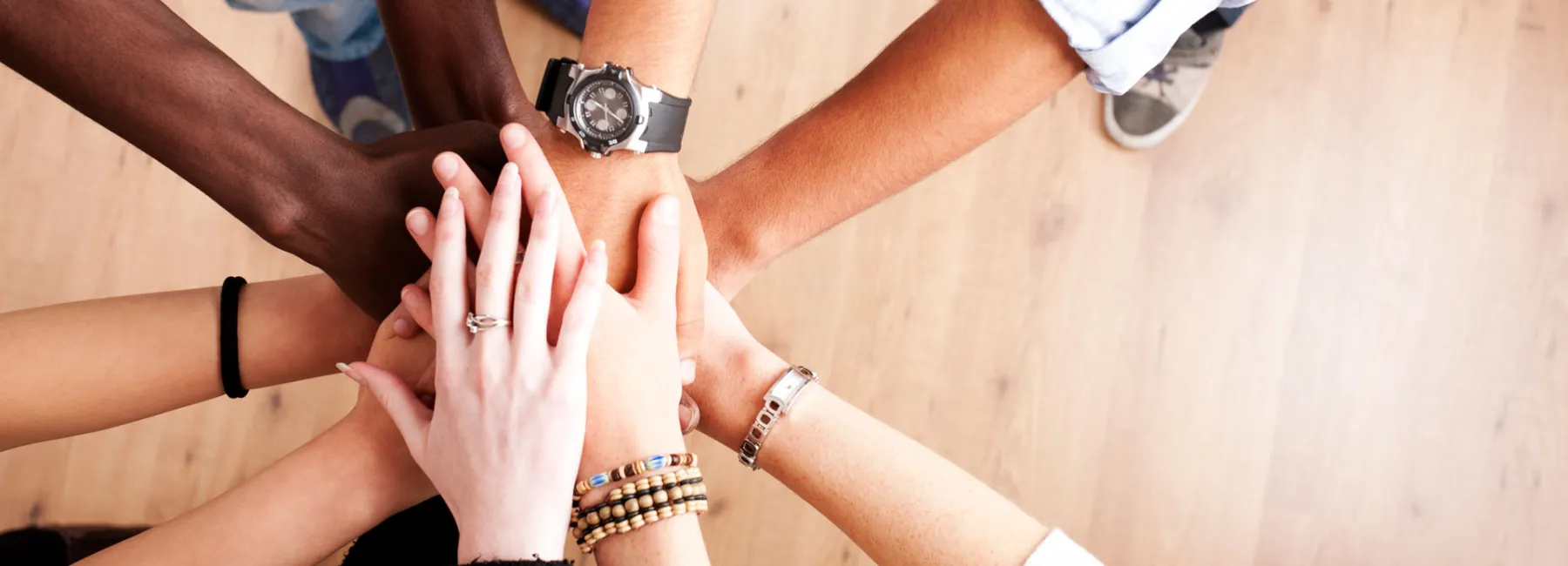 hands on top of each other in a circle