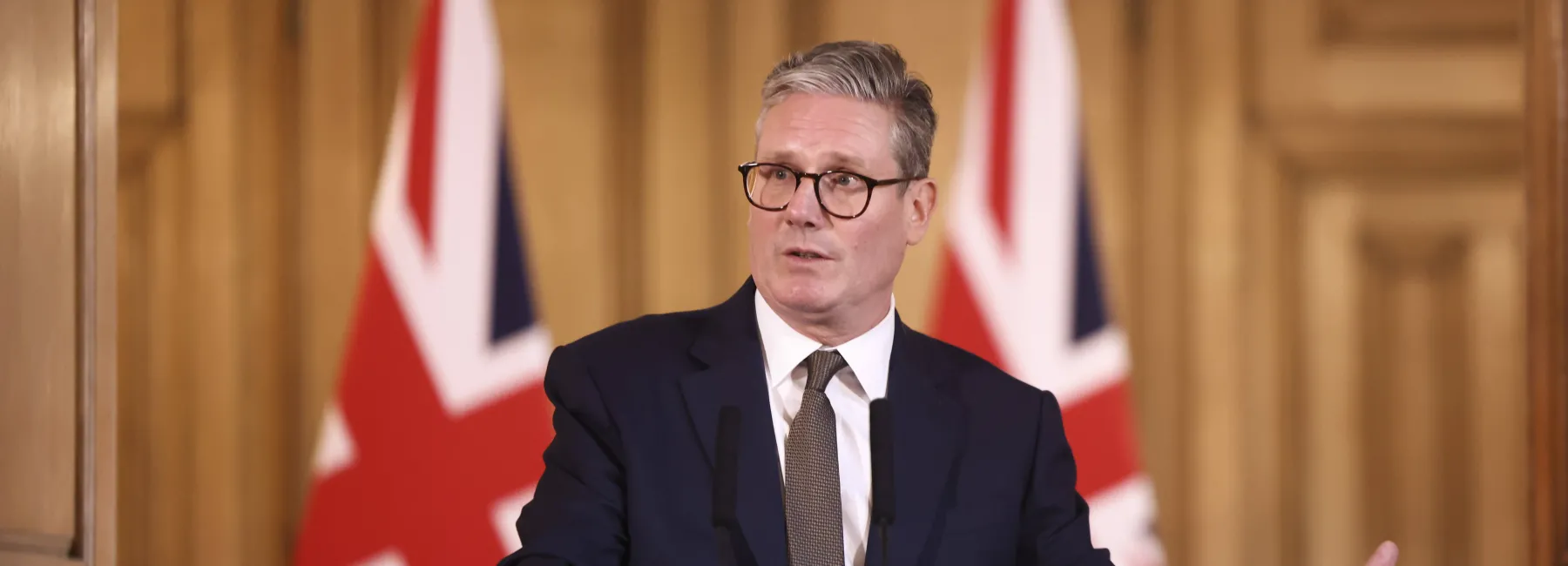 Keir Starmer giving a speech at a podium