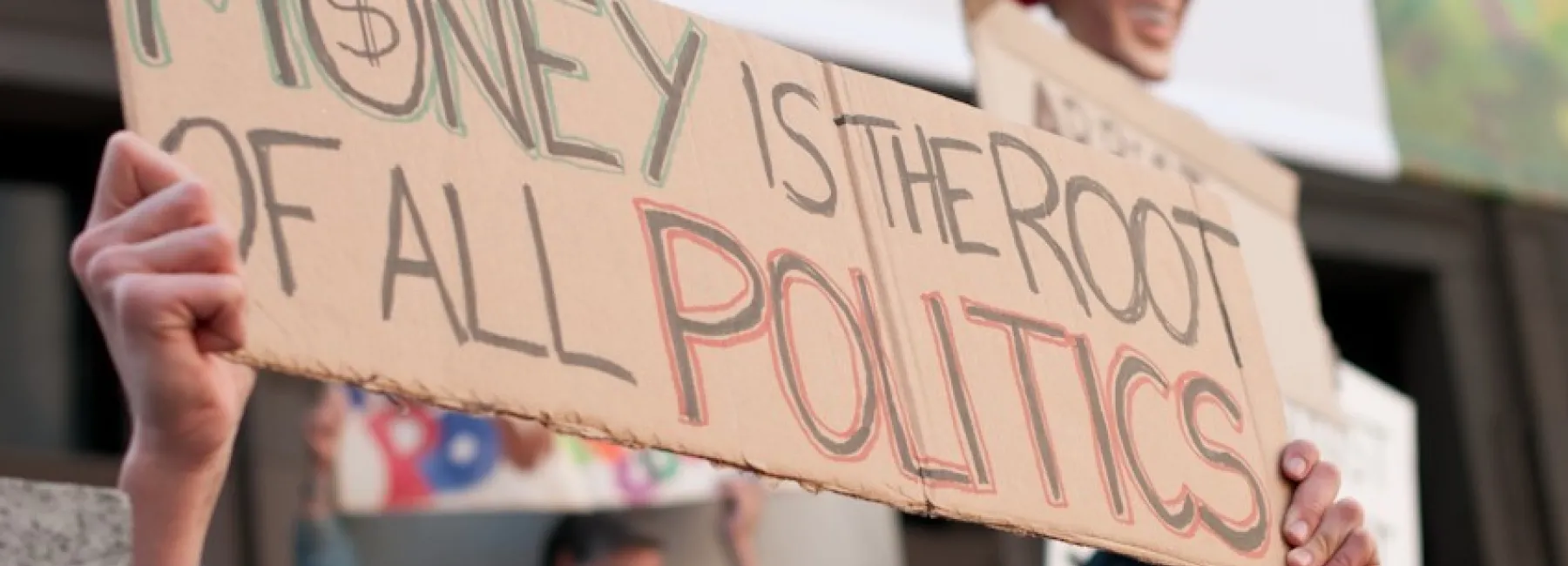 Money is the root of all politics sign