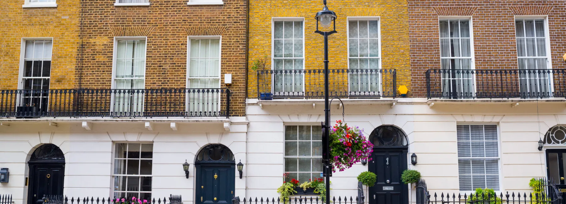 Facade of Georgian residential town houses made in yellow and red brick in a luxury residential area of West London.