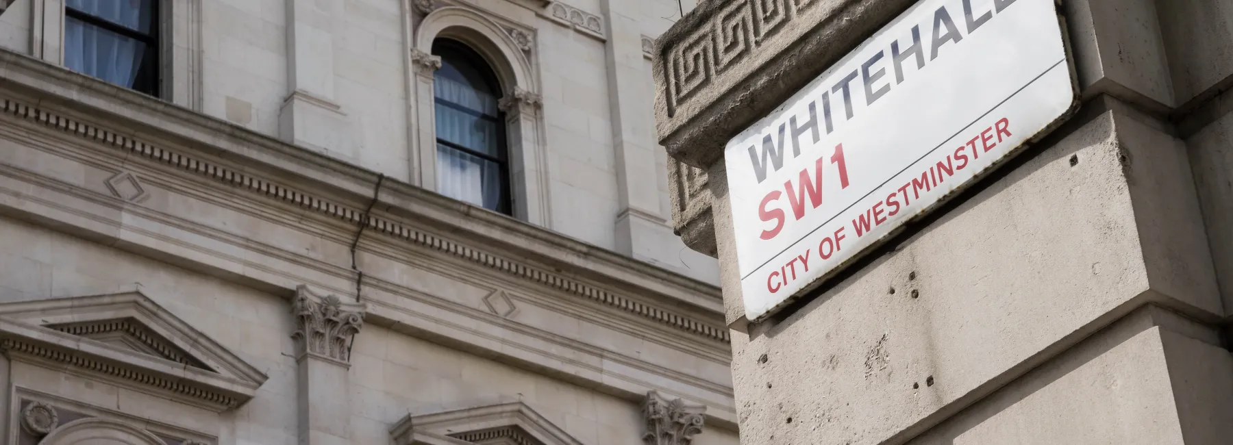 Whitehall street sign on the side of a government building