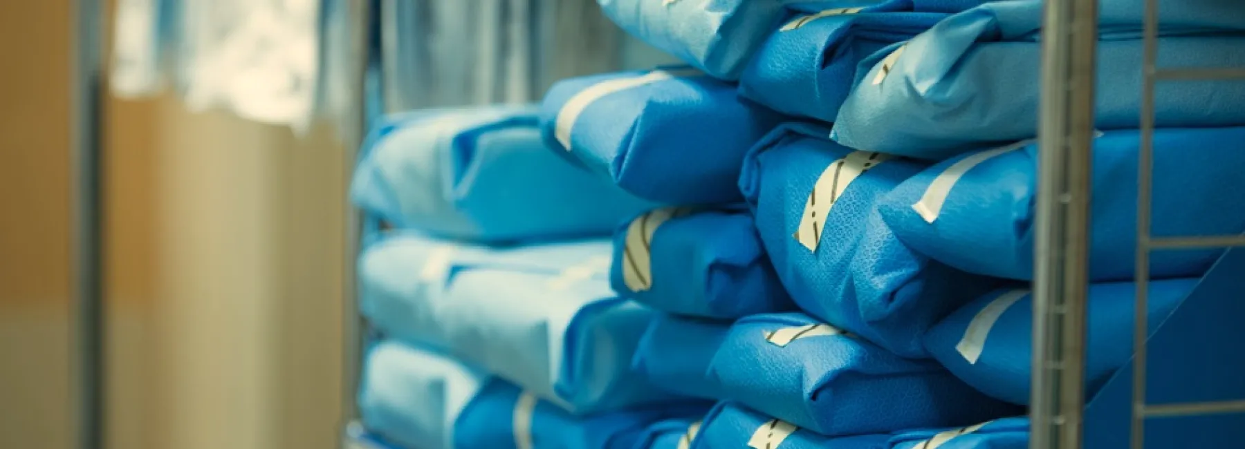 A pile of blue hospital gowns