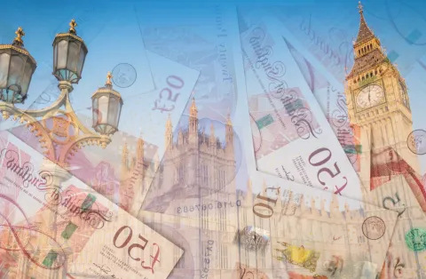 Pound notes in front of the Palace of Westminster