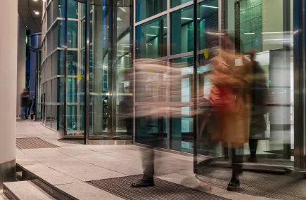 people passing through a revolving door