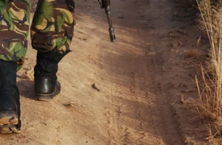 Soldier walking on a dirt road