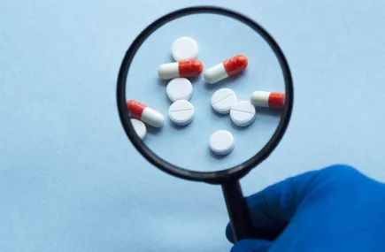 Magnifying glass and pills