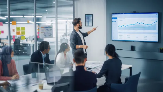Man giving presentation in front of a whiteboard.